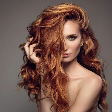 Vibrant red hair after professional hair coloring in Kennewick, WA, showcasing rich color, shine, and expert salon styling.