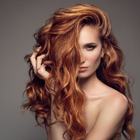 Vibrant red hair after professional hair coloring in Kennewick, WA, showcasing rich color, shine, and expert salon styling.